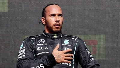 FILE PHOTO: Mercedes' Lewis Hamilton celebrates on the podium after winning the race. (Pool via REUTERS)