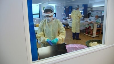 A member of staff takes off PPE in the HDU (High Dependency Unit) at Milton Keynes University Hospital, amid the spread of the coronavirus disease (COVID-19) pandemic. (Reoresentational) (REUTERS)
