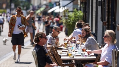 People dine outdoors at Broadway Market in Hackney, London, UK. (Bloomberg) People dine outdoors at Broadway Market in Hackney, London, UK. (Bloomberg)