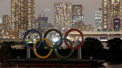 The Olympic Rings installed on a floating platform are seen in front of the city skyline ahead of the 2020 Tokyo Olympic Games on July 14. Tokyo reported 1,008 new COVID-19 cases on July 18, the fifth straight day with more than 1,000 cases. The Olympics will open on July 23 under a state of emergency in Tokyo and three neighbouring prefectures, AP reported. (Fabrizio Bensch / REUTERS) The Olympic Rings installed on a floating platform are seen in front of the city skyline ahead of the 2020 Tokyo Olympic Games on July 14. Tokyo reported 1,008 new COVID-19 cases on July 18, the fifth straight day with more than 1,000 cases. The Olympics will open on July 23 under a state of emergency in Tokyo and three neighbouring prefectures, AP reported. (Fabrizio Bensch / REUTERS)