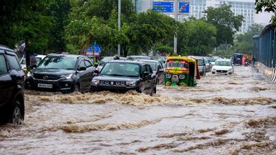 Vehicles wade through a waterlogged street after heavy rains near Medicity Hospital in Gurugram on Monday, July 19. (PTI) Vehicles wade through a waterlogged street after heavy rains near Medicity Hospital in Gurugram on Monday, July 19. (PTI)