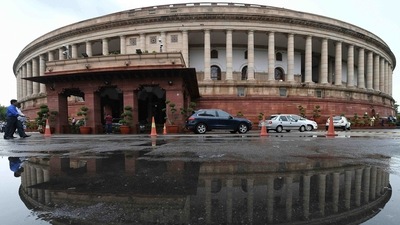The Parliament building reflected in a puddle after heavy rain during the monsoon session of the Parliament in New Delhi. (AP) The Parliament building reflected in a puddle after heavy rain during the monsoon session of the Parliament in New Delhi. (AP)