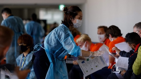 Members of the Dutch delegation await the Covid test upon arrival from Amsterdam at Narita International Airport, Chiba Prefecture, on July 18. Czech beach volleyball player Ondrej Perusic tested positive for Covid-19 in the Olympic Village on July 18. As of July 2, Tokyo 2020 organizers have reported 58 positive cases among athletes, officials and journalists, Reuters reported. (David Gannon / AFP)
