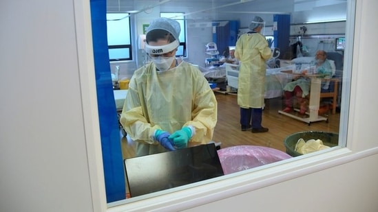 A member of staff takes off PPE in the HDU (High Dependency Unit) at Milton Keynes University Hospital, amid the spread of the coronavirus disease (COVID-19) pandemic. (Reoresentational)(REUTERS)