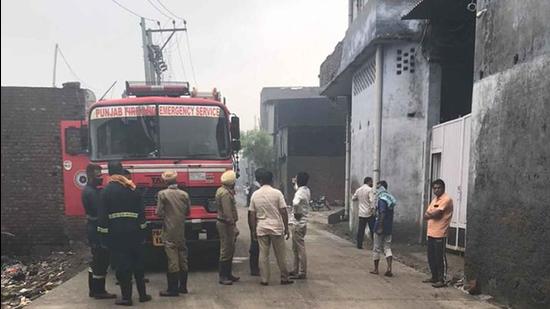 Firemen trying to douse the flames at the cardboard godown on Tejpur road in Ludhiana on Monday. (HT PHOTO)