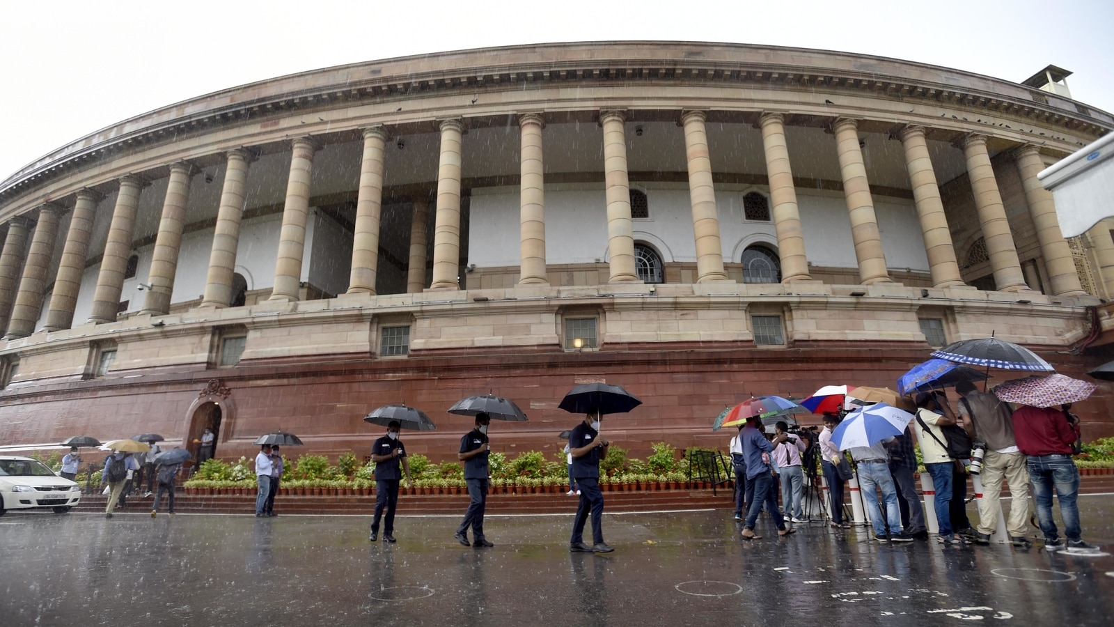 New Delhi, India. 19th July, 2021. Prime Minister Narendra Modi holds an  umbrella to protect from the rain as he addresses the media on the opening  day of the monsoon session of