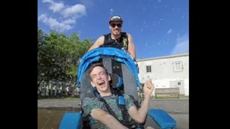 The image shows Brad and Dan enjoying among the water fountains.
