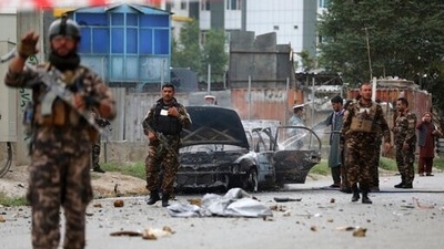 Security personnel inspect a damaged vehicle that was firing rockets in Kabul, Afghanistan, Tuesday, July 20, 2021. (AP)