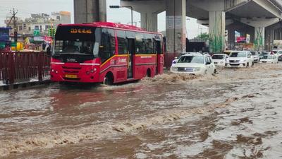 Vehicles making their way through a waterlogged road in Zirakpur on Tuesday. (HT PHOTO)