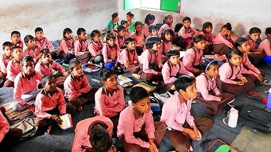 Students sitting on the floor and studying in a UP government upper primary school. (HT file photo)