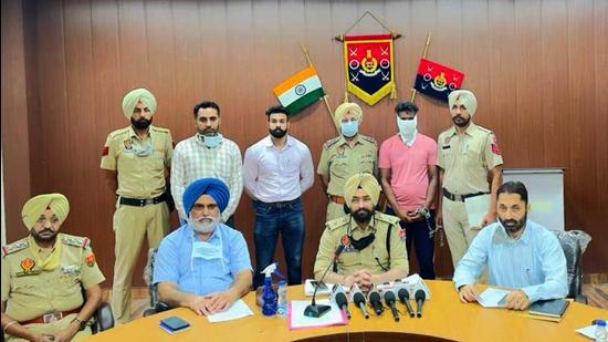The rape accused (in pink) in the custody of Jagraon police in Ludhiana on Tuesday. (HT Photo)