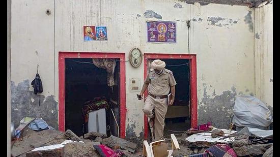 A policeman inspects the spot where the roof of a house collapsed after heavy rain at Matauli village in Patiala. (PTI)