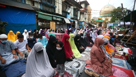 Filipino Muslims offer prayers outside a mosque in Manila City, suburban Manila on Tuesday. (Photo by STR/AFP)