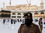 A Saudi police female officer stands guard as pilgrims perform final Tawaf during the annual Haj pilgrimage in Mecca, Saudi Arabia.