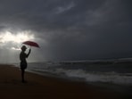A man holds an umbrella as it rains on the beach by the Bay of Bengal coast in Visakhapatnam, Andhra Pradesh state, India, Thursday, July 15, 2021.(AP) A man holds an umbrella as it rains on the beach by the Bay of Bengal coast in Visakhapatnam, Andhra Pradesh state, India, Thursday, July 15, 2021.(AP)