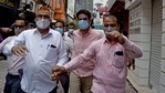 Police bring businessman Navneet Kalra to Khan Market in New Delhi on Tuesday. (ANI Photo) Police bring businessman Navneet Kalra to Khan Market in New Delhi on Tuesday. (ANI Photo)