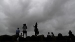 People sit by the sea shore in Mumbai.(AP) People sit by the sea shore in Mumbai.(AP)