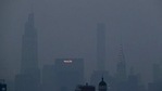 The Met Life and Chrysler buildings glow through a thick haze hanging over Manhattan,(AP) The Met Life and Chrysler buildings glow through a thick haze hanging over Manhattan,(AP)