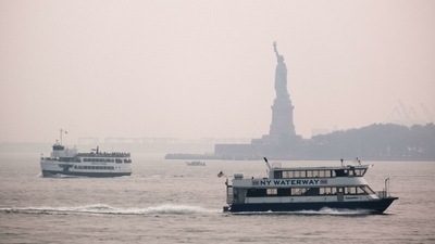 The Statue of Liberty sits behind a cloud of haze in New York City on July 20. According to data from the National Oceanic and Atmospheric Administration, wildfire smoke from the west has arrived in the tri-state area creating decreased visibility and a yellowish haze in many areas. (Spencer Platt / AFP) The Statue of Liberty sits behind a cloud of haze in New York City on July 20. According to data from the National Oceanic and Atmospheric Administration, wildfire smoke from the west has arrived in the tri-state area creating decreased visibility and a yellowish haze in many areas. (Spencer Platt / AFP)