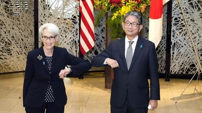 US deputy secretary of state Wendy Sherman (left) elbow bumps with Japanese vice-minister for foreign affairs Takeo Mori prior to their meeting in Tokyo, on Tuesday (AP) US deputy secretary of state Wendy Sherman (left) elbow bumps with Japanese vice-minister for foreign affairs Takeo Mori prior to their meeting in Tokyo, on Tuesday (AP)