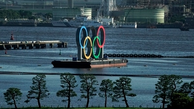 A barge with the Olympic rings mounted on it floats in the water ahead of the 2020 Summer Olympics (AP)