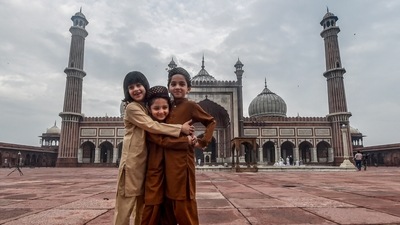 Muslim children greet each other on the occasion of Eid al-Adha at the Jama Masjid, wearing an almost deserted look due to Covid-19 pandemic, in New Delhi, Wednesday, July 21, 2021. (PTI)