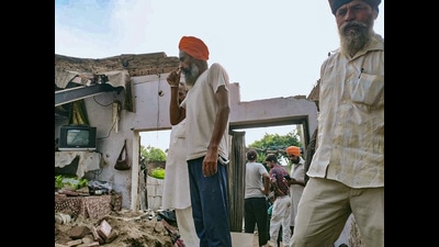 Villagers at the house where the roof came crashing down at Dhudhan Sandha village in Patiala. (PTI) Villagers at the house where the roof came crashing down at Dhudhan Sandha village in Patiala. (PTI)