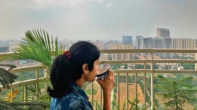Divya Babu is enjoying this magical sight perched far above the wet earth mired in flooded underpasses and traffic jams—on the balcony of her 30th floor apartment in Gurugram’s Sector 54. (Mayank Austen Soofi) Divya Babu is enjoying this magical sight perched far above the wet earth mired in flooded underpasses and traffic jams—on the balcony of her 30th floor apartment in Gurugram’s Sector 54. (Mayank Austen Soofi)