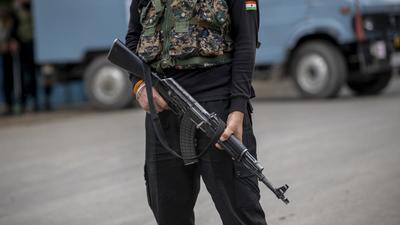 An Indian paramilitary soldier stands guard in on road in Kashmir. (AP)