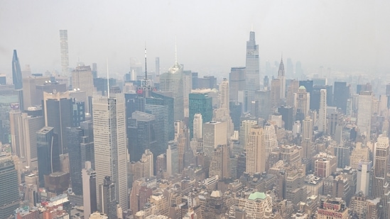 The New York City skyline is seen through a cover of wildlife smoke from the Edge at Hudson Yards in New York, on July 20. Skies over New York City were hazy Tuesday as strong winds blew smoke east from California, Oregon, Montana and other states. Oregon's Bootleg Fire grew to 606 square miles (1,569 square kilometres) — half the size of Rhode Island, AP reported.(Jeenah Moon / REUTERS)