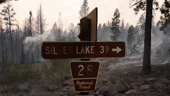 A burned sign in sight as the Bootleg Fire burns through vegetation near Paisley, Oregon on July 20. At least 2,000 homes have been evacuated at some point during the fire and another 5,000 threatened. At least 70 homes and more than 100 outbuildings have gone up in flames, AP reported.(David Ryder / REUTERS)