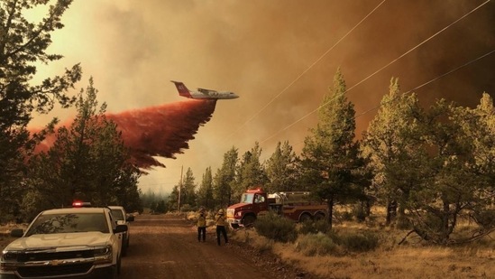 A firefighting tanker drops a retardant over the Grandview fire near Sisters, Oregon on July 11. A red flag weather warning signifying dangerous fire conditions was in effect through Tuesday and possibly longer. The fire is 30% contained, AP reported.(Oregon Department of Forestry / AFP)