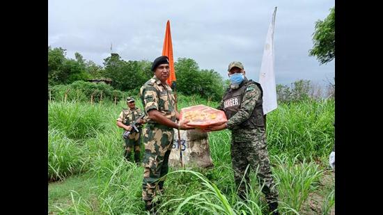 Sweets and pleasantries were exchanged between the BSF and Pakistan Rangers along the international border in Jammu region to celebrate Eid. (Sourced) Sweets and pleasantries were exchanged between the BSF and Pakistan Rangers along the international border in Jammu region to celebrate Eid. (Sourced)