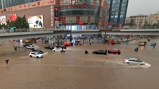 Vehicles are stranded after a heavy downpour in Zhengzhou city, central China's Henan province on Tuesday, July 20, 2021. (AP) Vehicles are stranded after a heavy downpour in Zhengzhou city, central China's Henan province on Tuesday, July 20, 2021. (AP)