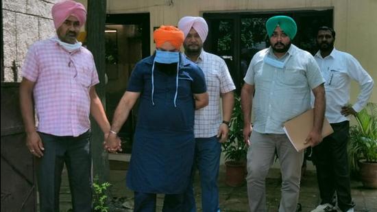 Accused Pritpal Singh in the custody of Mohali vigilance department after his arrest on Wednesday. (HT Photo) Accused Pritpal Singh in the custody of Mohali vigilance department after his arrest on Wednesday. (HT Photo)
