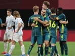 Australia's players celebrate their win after the Tokyo Olympic Games men's group C first round football against Argentina. 