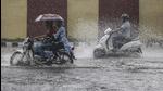 Commuters wade through a waterlogged area during rainfall in Jammu earlier this month. (File photo) Commuters wade through a waterlogged area during rainfall in Jammu earlier this month. (File photo)