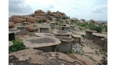 Megalithic Site of Hire Benkal (Karnataka): The last of the pyramids were still being built in Egypt when this massive burial complex was completed. The 2,500-year-old site, an hour’s drive from Hampi, looks like a deserted village of stone houses. The “houses” are actually megalithic funerary monuments, stone structures built to commemorate the dead in this part of Karnataka. Each of the 1,000 structures was meant to help the person interred enjoy a comfortable afterlife. Partial excavations near the site have revealed bones, ash, grave goods like pottery and grain, iron implements like fishhooks and arrows. The Hire Benkal site also contains 11 prehistoric rock shelters, with paintings that date back to 700 BCE to 500 BCE. The paintings depict animals, birds, insects and human figures (some are holding hands, others riding horses or hunting). (Meena Iyer)