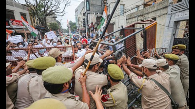 Police trying to stop Congress workers who were trying to gherao the governer’s house over fuel price hike in Jammu on Thursday. (PTI)