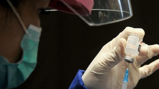 A medical worker prepares to administer the Covid-19 coronavirus vaccine during a vaccination drive.(AFP) A medical worker prepares to administer the Covid-19 coronavirus vaccine during a vaccination drive.(AFP)