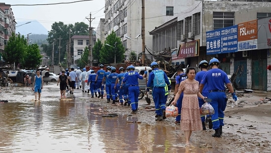 Rainwater has damaged more than 215,200 hectares of crops, causing a direct economic loss of about 1.22 billion yuan (about USD 188.6 million), state-run Xinhua news agency reported. (Photo by JADE GAO/AFP)