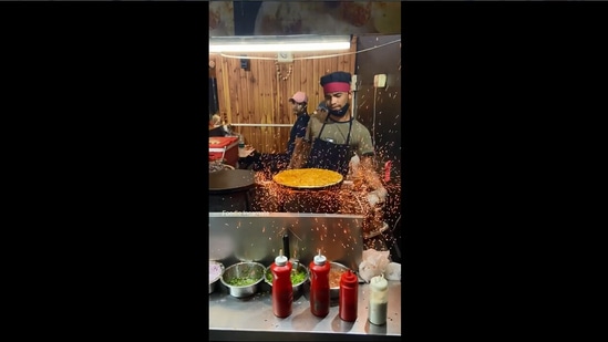The image shows a man making the 'fire dosa'.(foodie_incarnate)