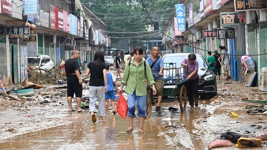 Residents of the storm-ravaged central Chinese city of Zhengzhou on July 22 were shovelling mud from their homes and hauling away wrecked cars and piles of destroyed belongings following floods in the city and surrounding areas.(Photo by JADE GAO/AFP)