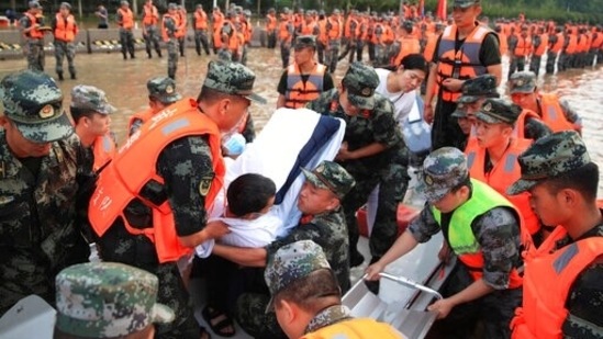 Chinese military personnel evacuate residents from a hospital where about 3,000 people were trapped. (AP)