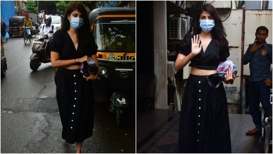 Rhea teamed the top with a skirt that had front button-down details and a flowy silhouette. She wore gold strappy sandals, a face mask and a black clutch with her outfit.(Varinder Chawla)