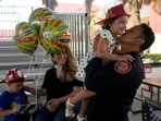 Members of Miami-Dade Fire Rescue's urban search and rescue team are reunited with their families after weeks of working on the rubble pile at the collapsed Champlain Towers South condominium.(AP) Members of Miami-Dade Fire Rescue's urban search and rescue team are reunited with their families after weeks of working on the rubble pile at the collapsed Champlain Towers South condominium.(AP)