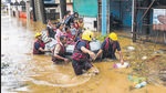 Municipal corporation firefighters during a rescue operation after heavy rain in Kolhapur, on July 22, 2021. Panchganga river flowing at warning level. (PTI) Municipal corporation firefighters during a rescue operation after heavy rain in Kolhapur, on July 22, 2021. Panchganga river flowing at warning level. (PTI)