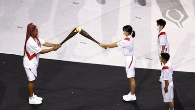 The Tokyo 2020 Olympics opening ceremony: It was eventually passed on to Japanese tennis star Naomi Osaka. (TWITTER) The Tokyo 2020 Olympics opening ceremony: It was eventually passed on to Japanese tennis star Naomi Osaka. (TWITTER)
