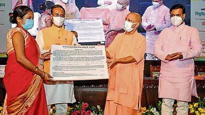 Uttar Pradesh chief minister Yogi Adityanath and deputy chief minister Dinesh Sharma distributing joining letters to assistant teachers under the Mission Rozgaar scheme at a function in Lucknow on Friday. (SOURCED ) Uttar Pradesh chief minister Yogi Adityanath and deputy chief minister Dinesh Sharma distributing joining letters to assistant teachers under the Mission Rozgaar scheme at a function in Lucknow on Friday. (SOURCED )