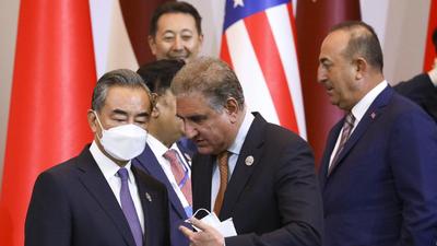 Chinese foreign minister Wang Yi (left) listens to his Pakistani counterpart Shah Mahmood Qureshi at the Central and South Asia 2021 conference in Tashkent, Uzbekistan, on July 16. (AP) Chinese foreign minister Wang Yi (left) listens to his Pakistani counterpart Shah Mahmood Qureshi at the Central and South Asia 2021 conference in Tashkent, Uzbekistan, on July 16. (AP)